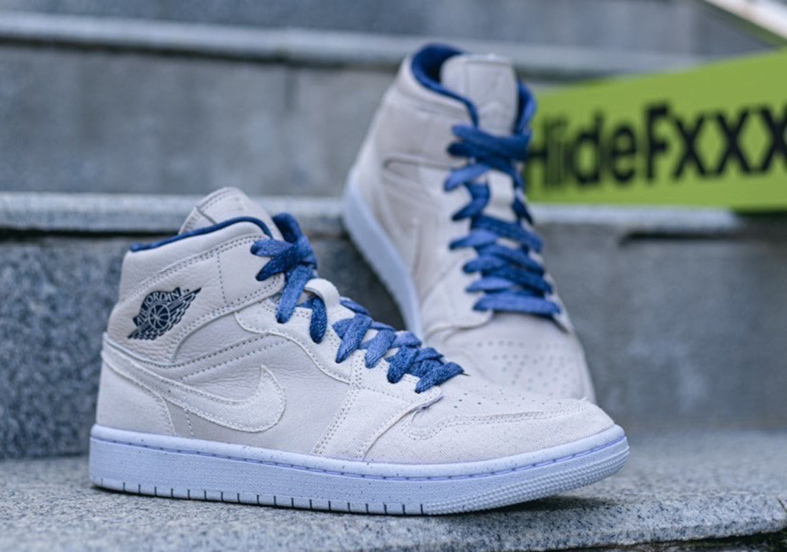 "Coconut Milk" và Vải màu đi kèm với các điểm nhấn màu chàm xuất hiện trên Air Jordan 1 Mid mới nhất.